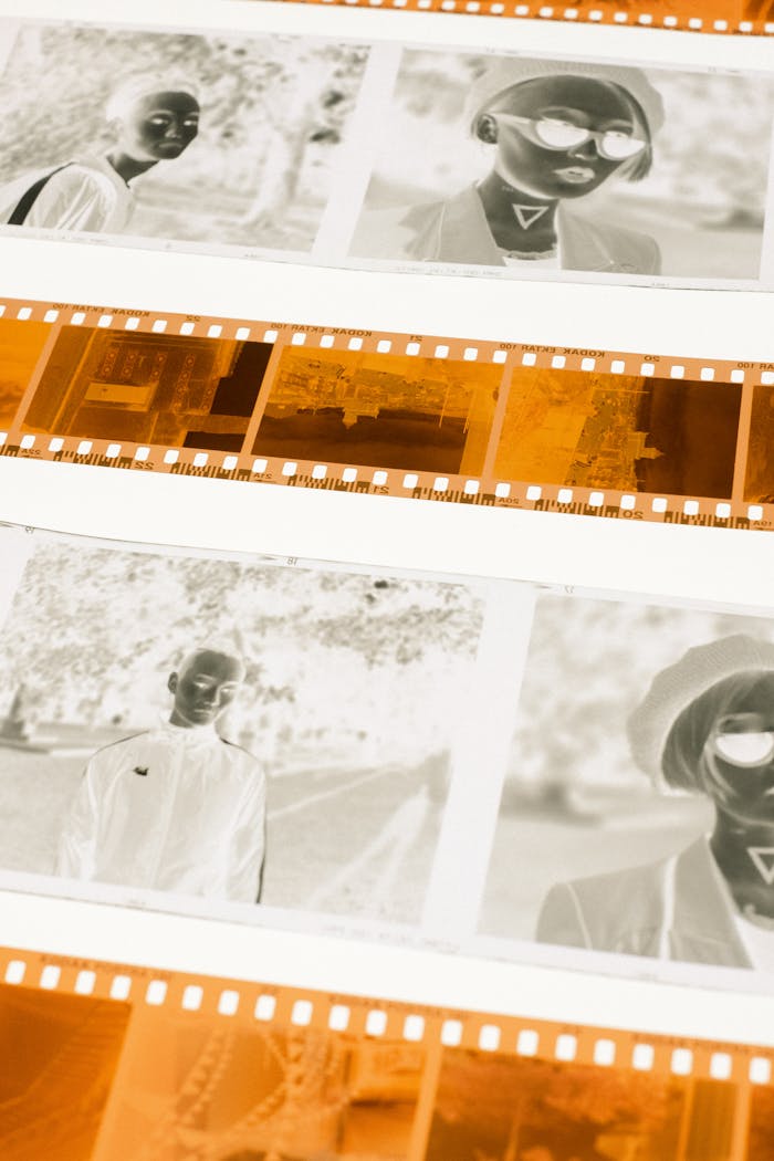 Detailed view of camera film negatives showcasing portrait close-ups in a photographic style.
