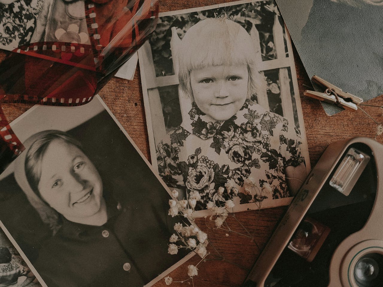 A nostalgic display of vintage family photos with retro camera and film negatives.